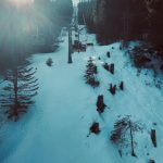 a ski lift going up a snowy hill